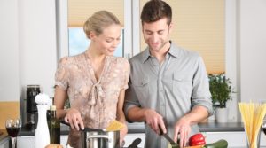man and women cooking in the kitchen