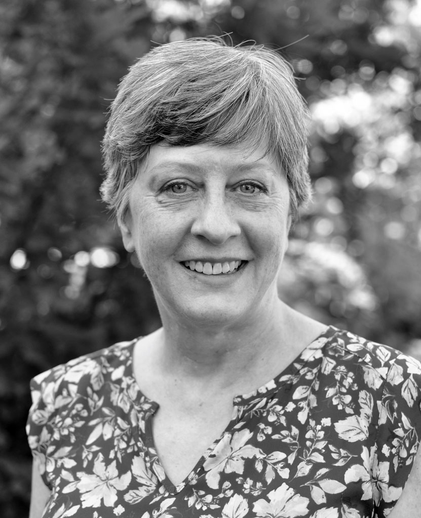 Headshot of Chris Carsten smiling in black and white