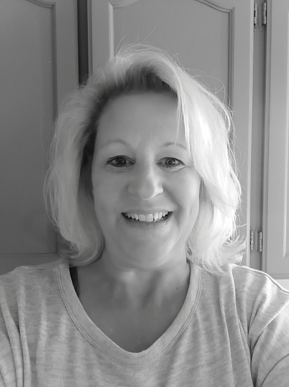 Headshot of Deb Schoonover smiling in black and white