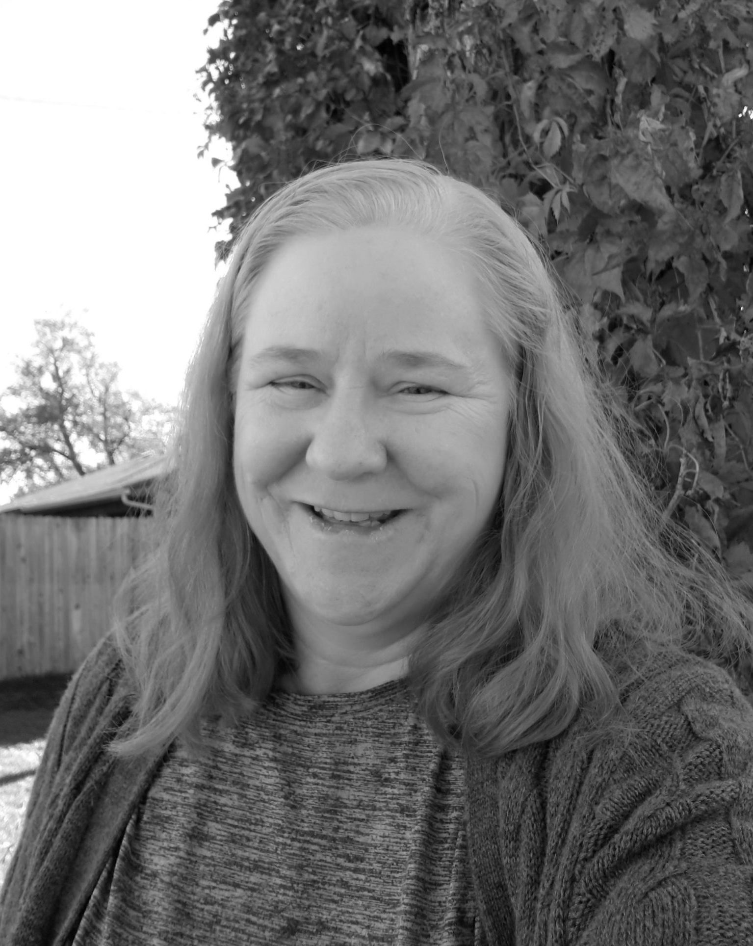 Headshot of Donna Willard smiling in black and white