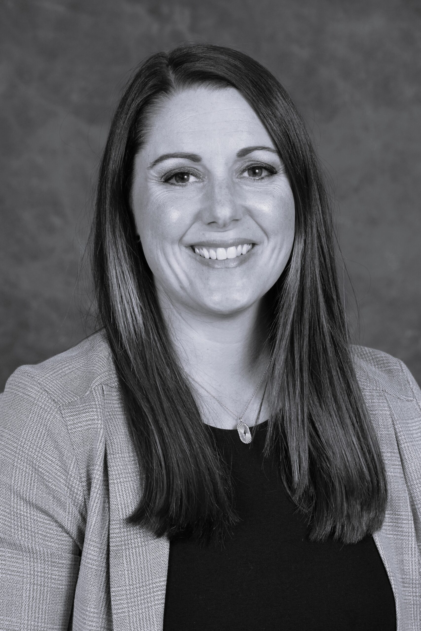 Headshot of Erin Lemoine smiling in black and white
