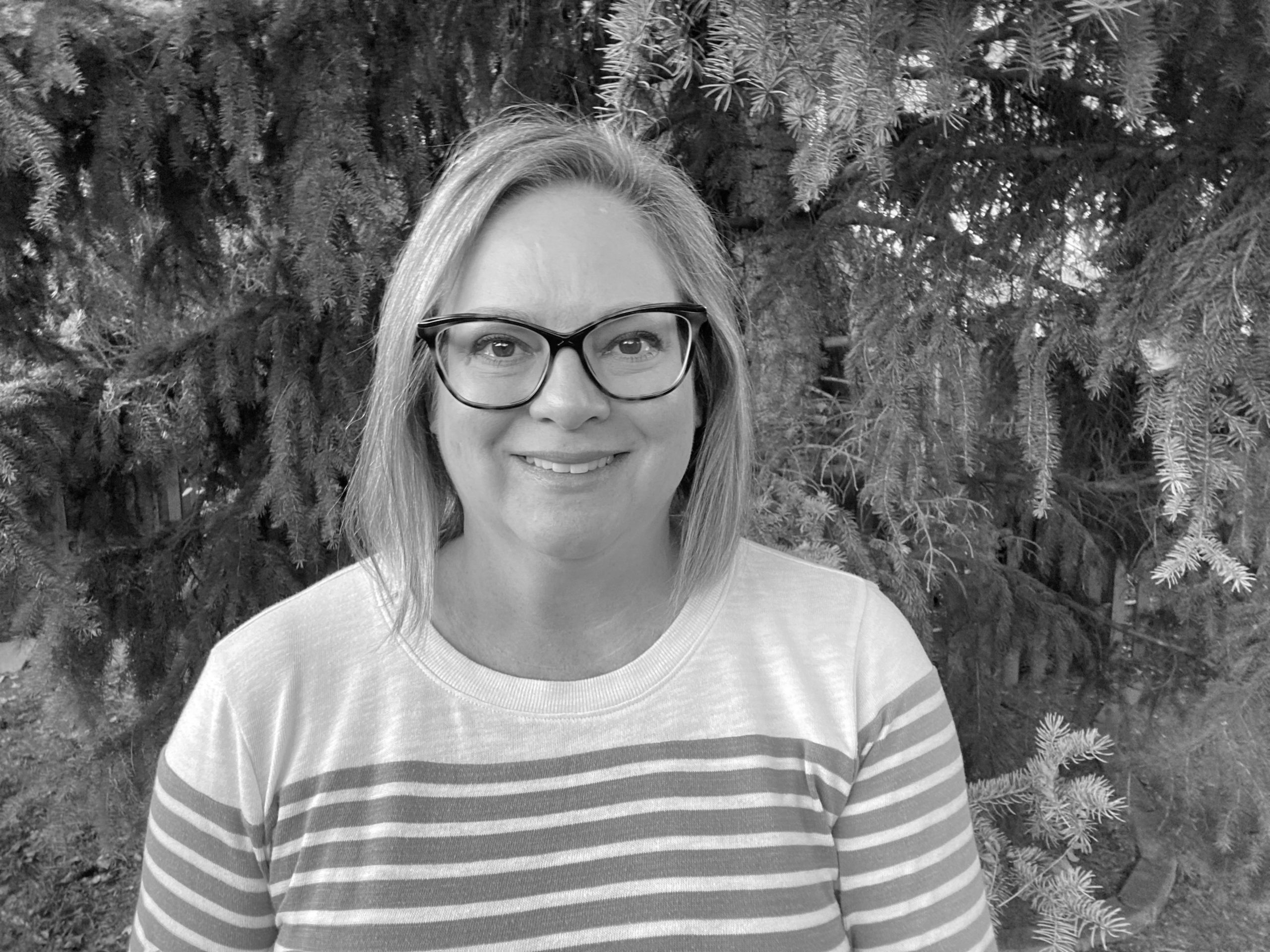 Headshot of Shannon Irey smiling in black and white