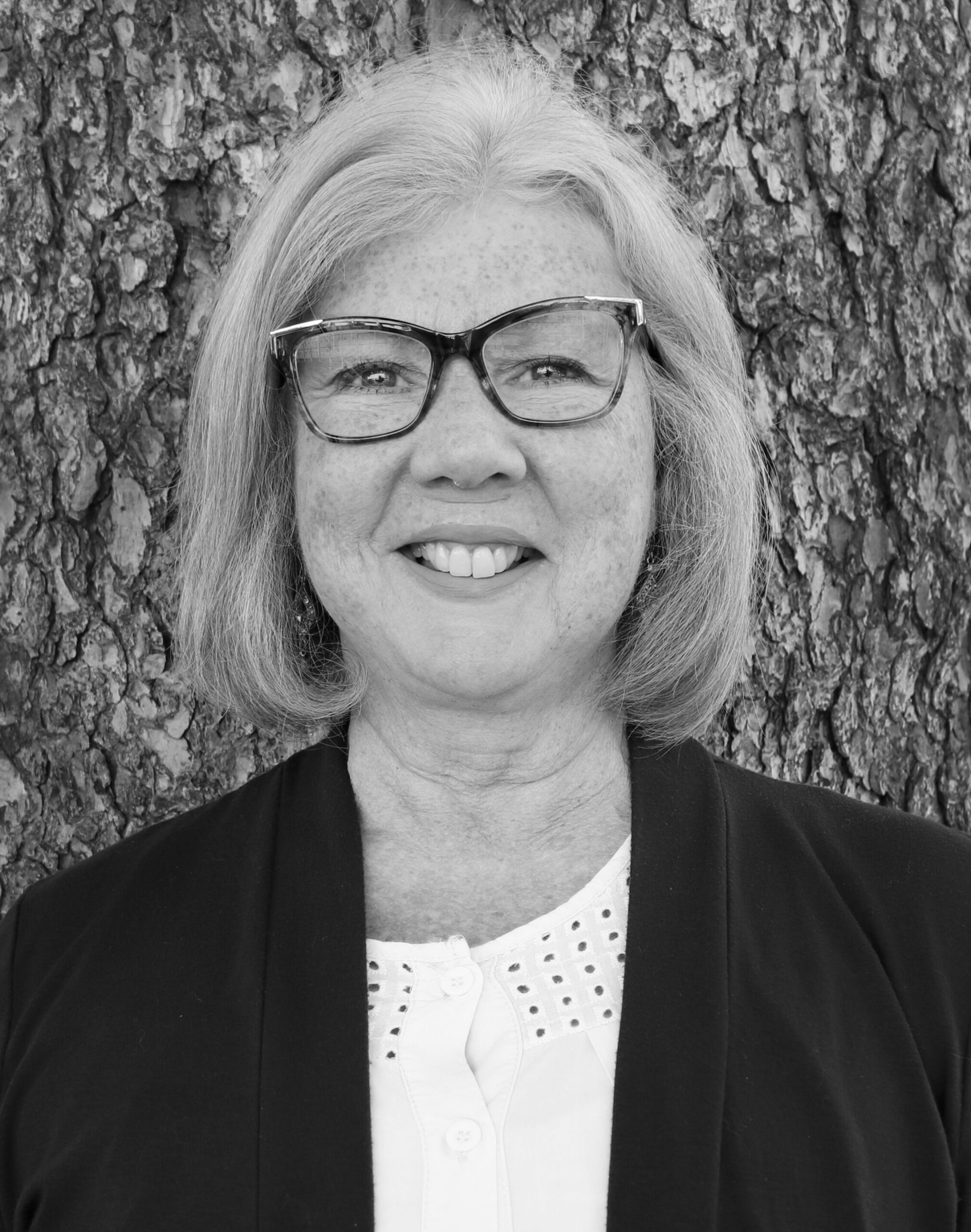 Image of Kathy Aitchison smiling in black and white.