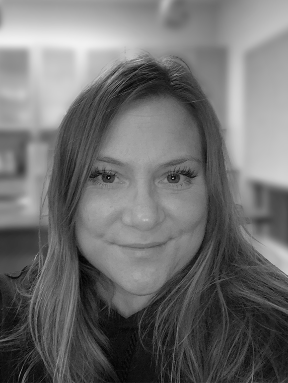 Headshot of Katie McGirr smiling in black and white