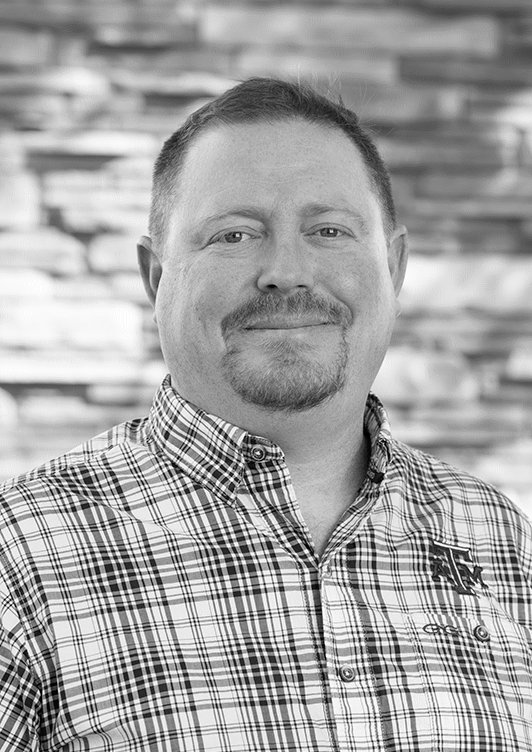 Headshot of Micheal Lang smiling in black and white