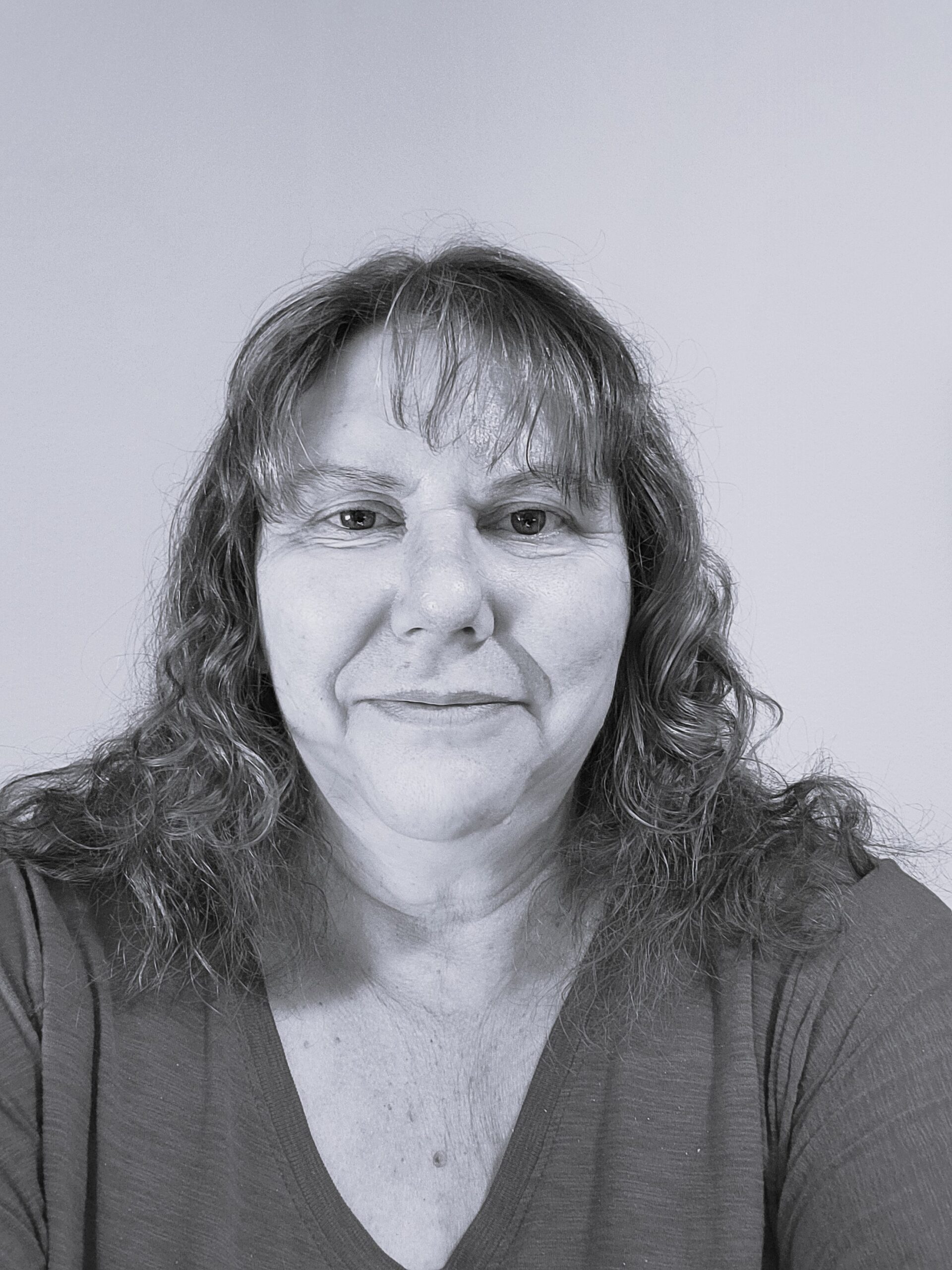 Headshot of Michelle Barraclough smiling in black and white.