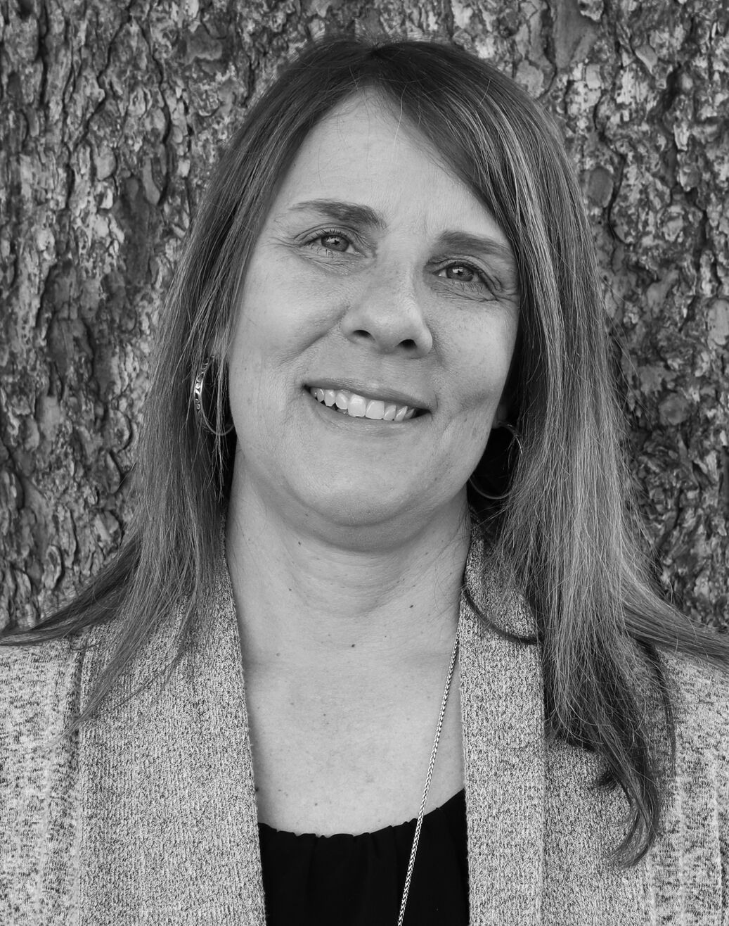 Headshot of Kris Miller smiling in black and white