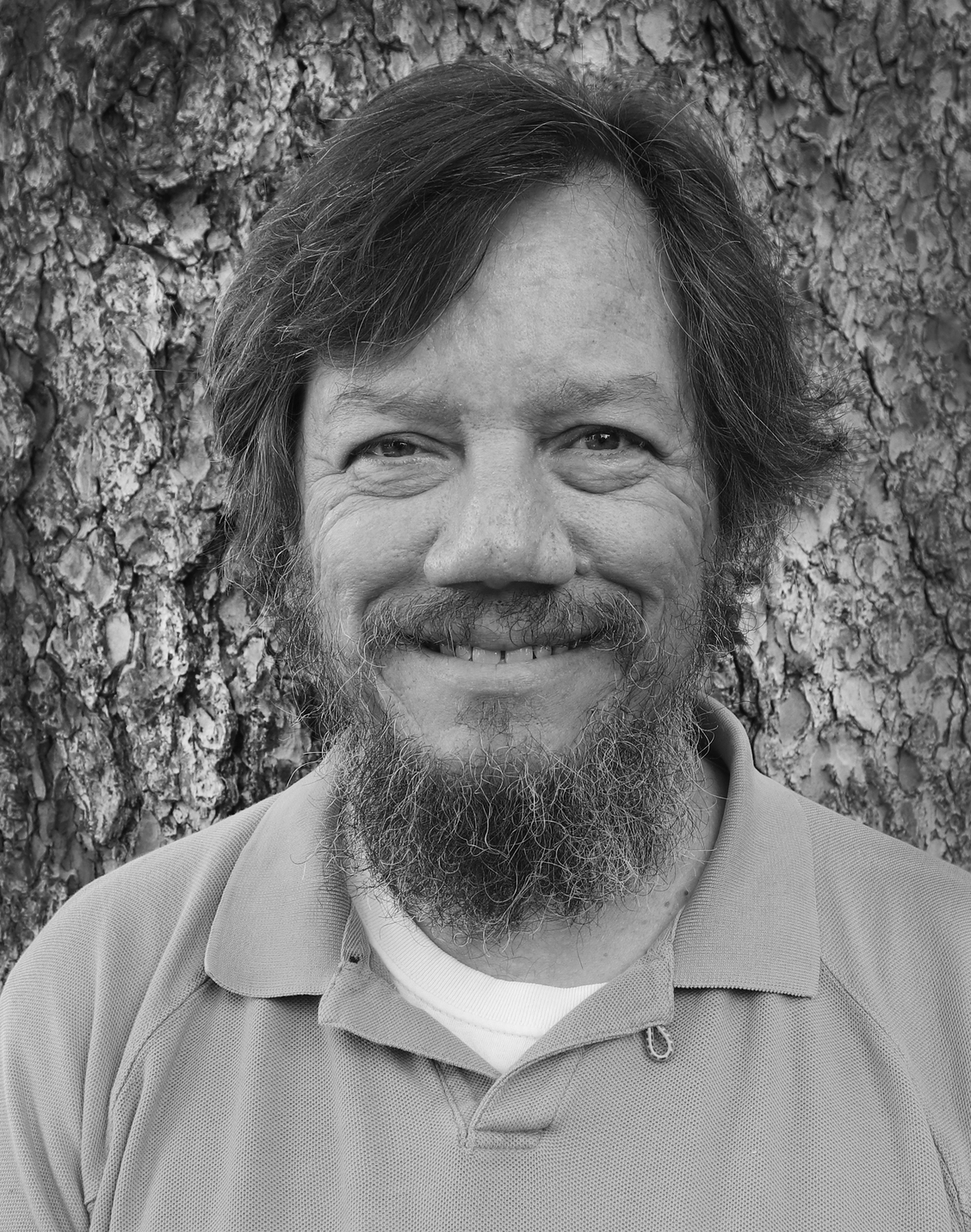 Headshot of Steve Crawford smiling in black and white