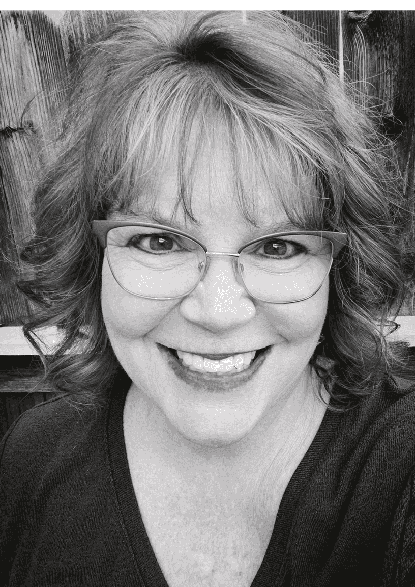 Headshot of Julie Harvey smiling in black and white