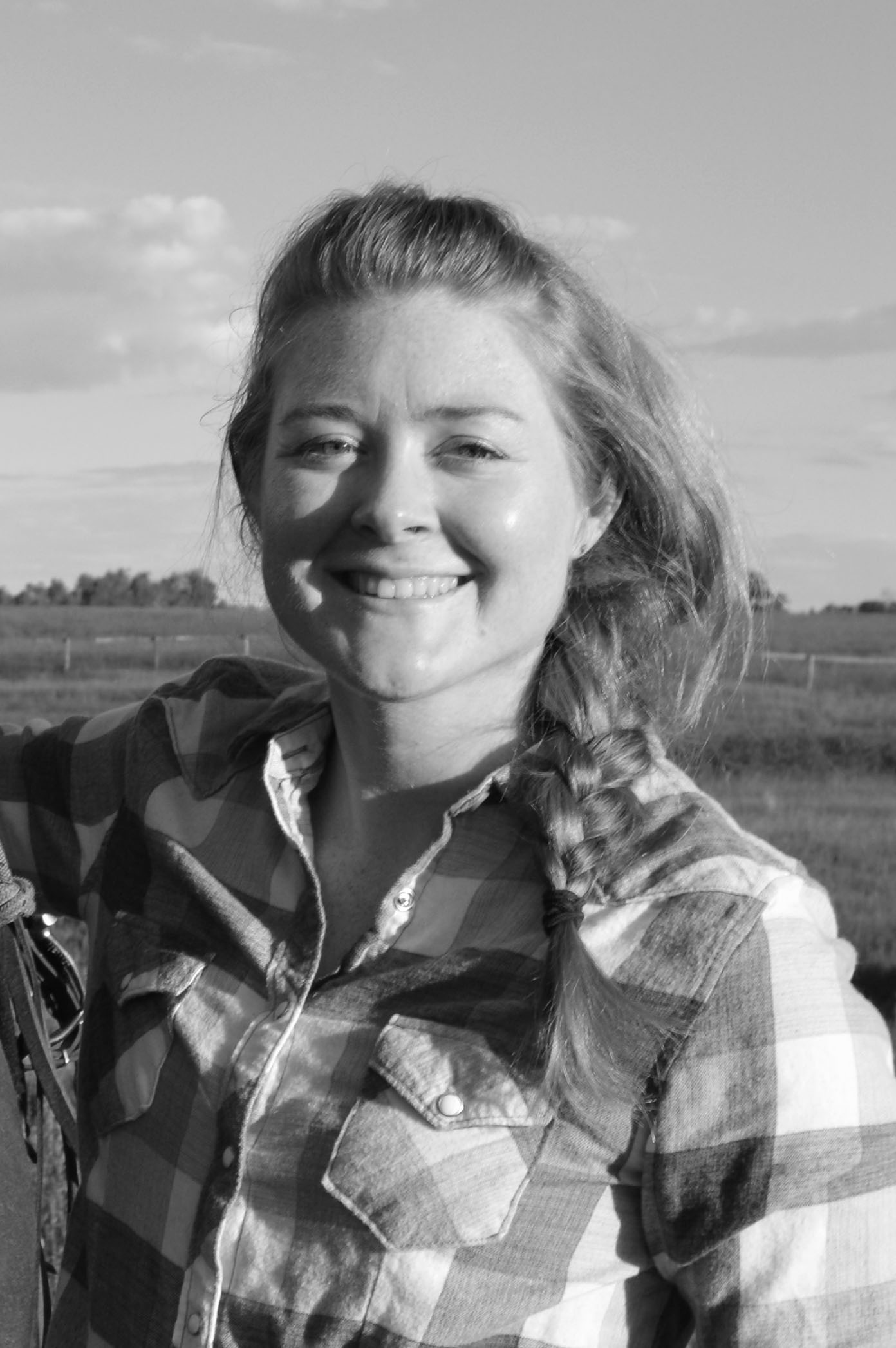 Headshot of Leigh Cooper smiling in black and white