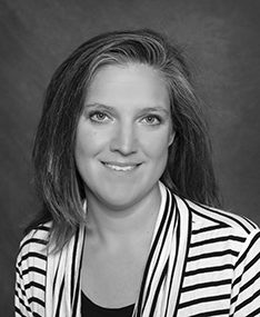headshot of Trisha Southergill smiling in black and white